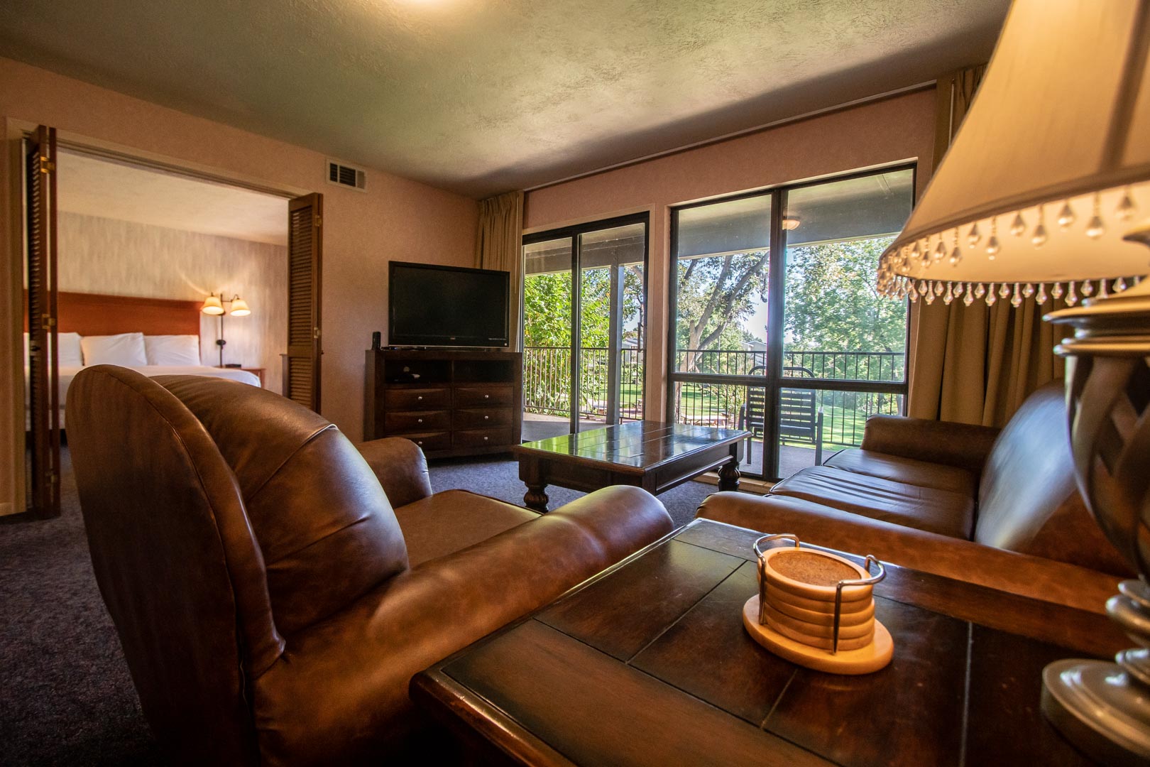 A living room area with access to the balcony at VRI's Sweetwater at Lake Conroe in Montgomery, TX.